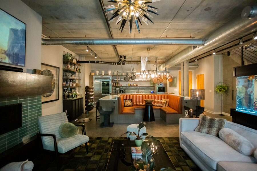 Twin Cities industrial home remodel: concrete ceiling, exposed ductwork, large kitchen booth.