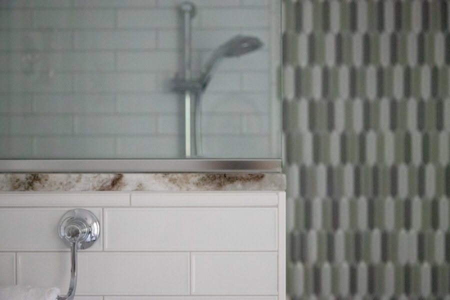 Elegant Twin Cities bathroom renovation integrates subway tiles, granite, glass shower.