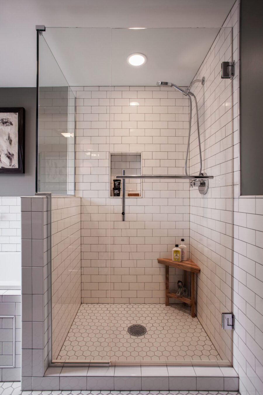 Twin Cities bathroom renovation features white subway, hexagonal tiles, glass shower.