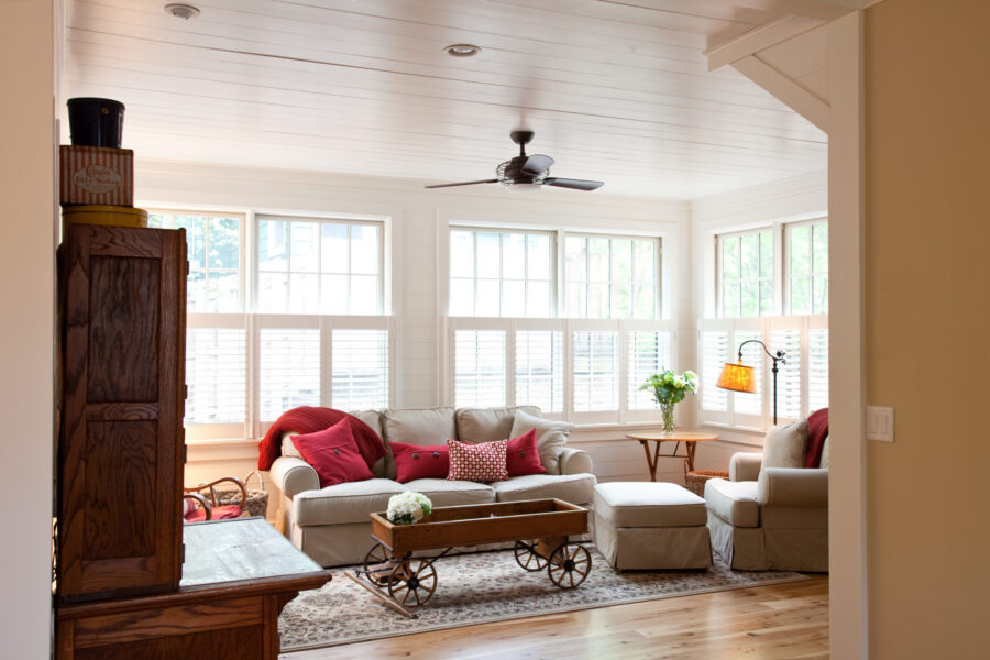 Renovated residence features crisp white paneling, lustrous wood flooring, ambient illumination.