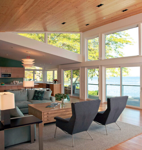 Modern kitchen-living design-build renovation boasts vaulted wood ceiling, expansive lake views.