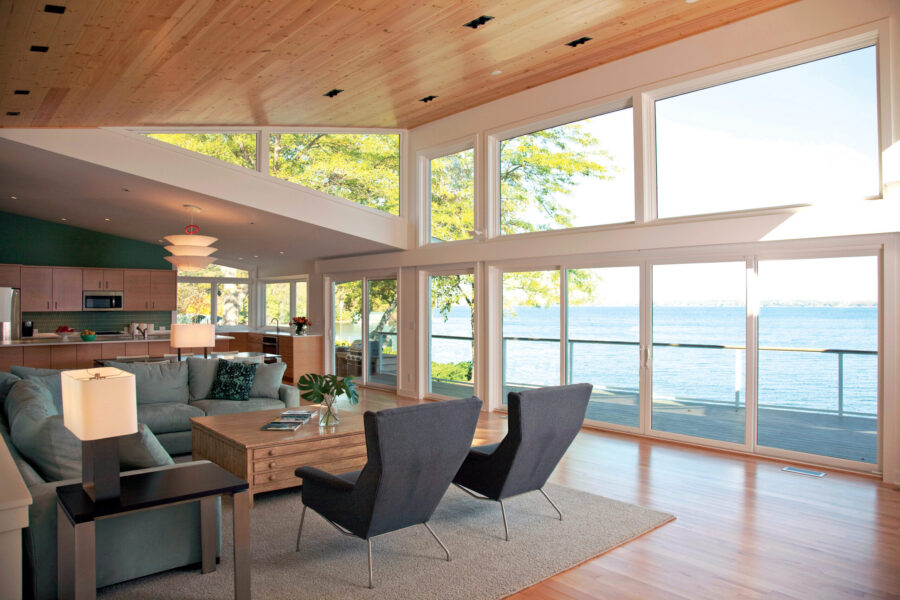 Modern kitchen-living design-build renovation boasts vaulted wood ceiling, expansive lake views.