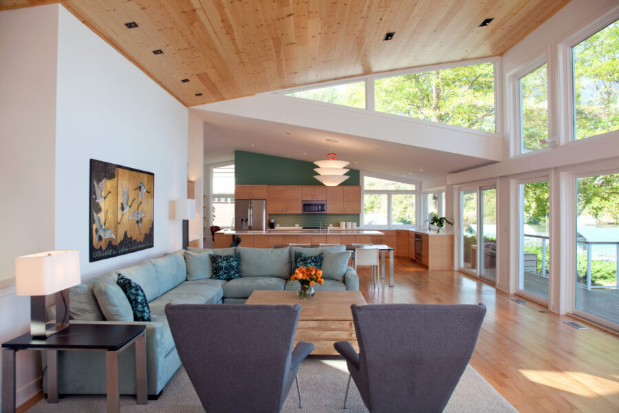 A modern open concept Twin Cities home renovation features a wood ceiling, bright kitchen, and lake-view living room.