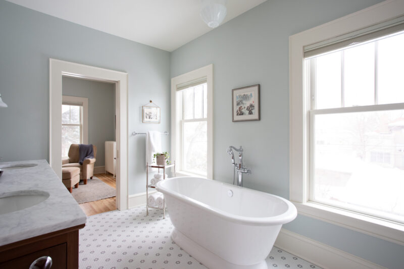 Bright Twin Cities bathroom remodel, freestanding tub, vanity, patterned tile.