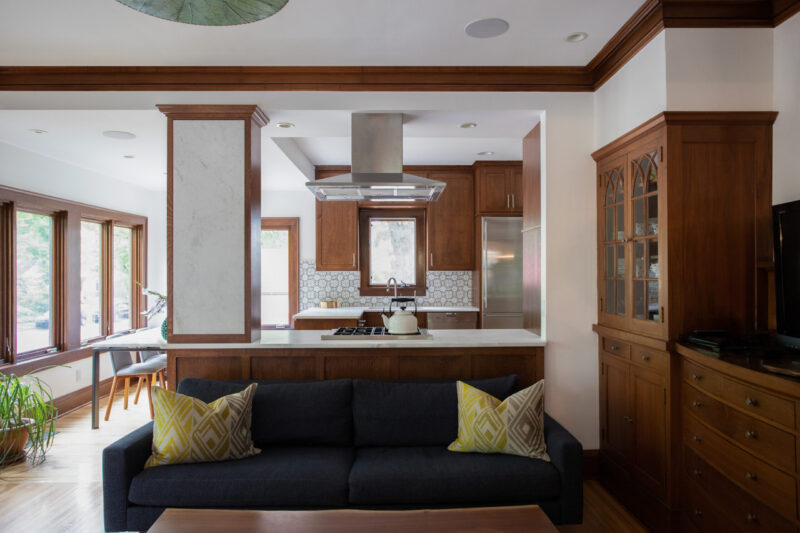 Twin-Cities home-renovation integrates open-concept kitchen, warm wood, marble, stainless.