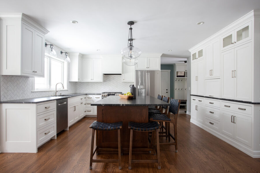 Twin Cities kitchen remodel: white cabinetry, dark island-counters, hardwood flooring.