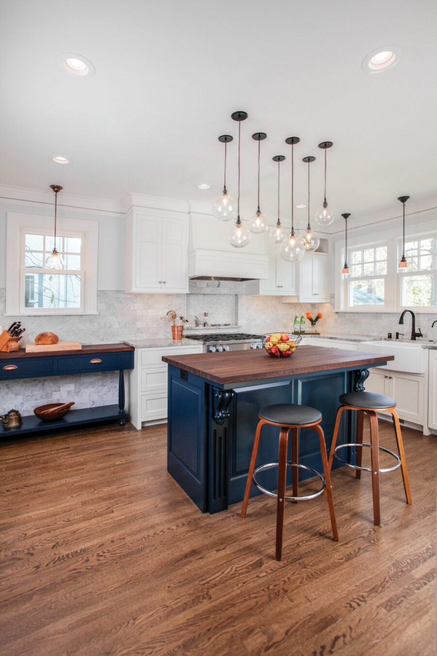 Renovated Twin Cities kitchen. Blue island, white cabinetry, hardwood floor.