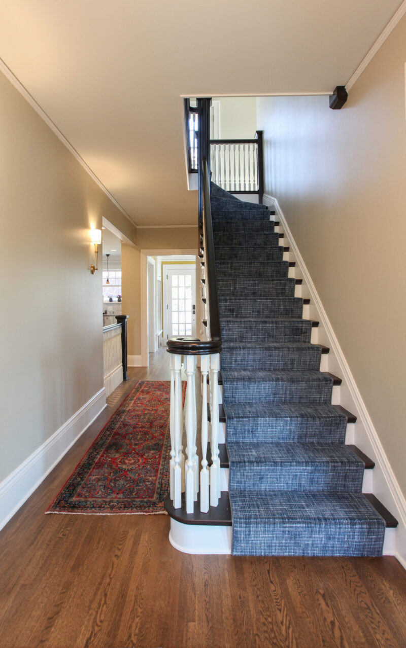 Architecturally renovated TwinCities entryway. Dark hardwoods. Patterned carpeting. Balustrade.
