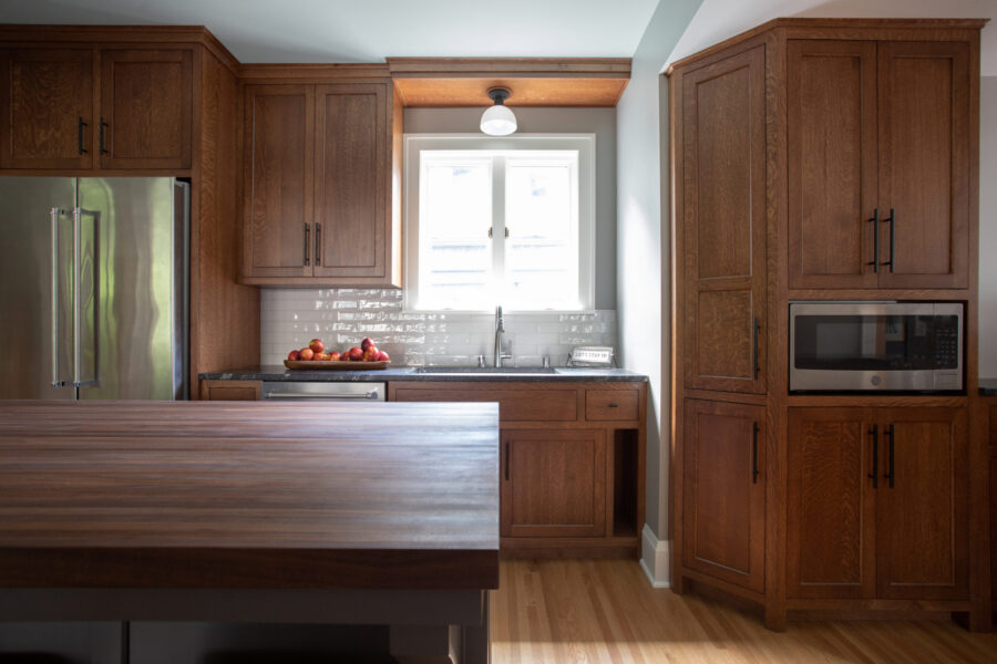 Dark wood kitchen cabinetry defines extensive Twin Cities home renovation.