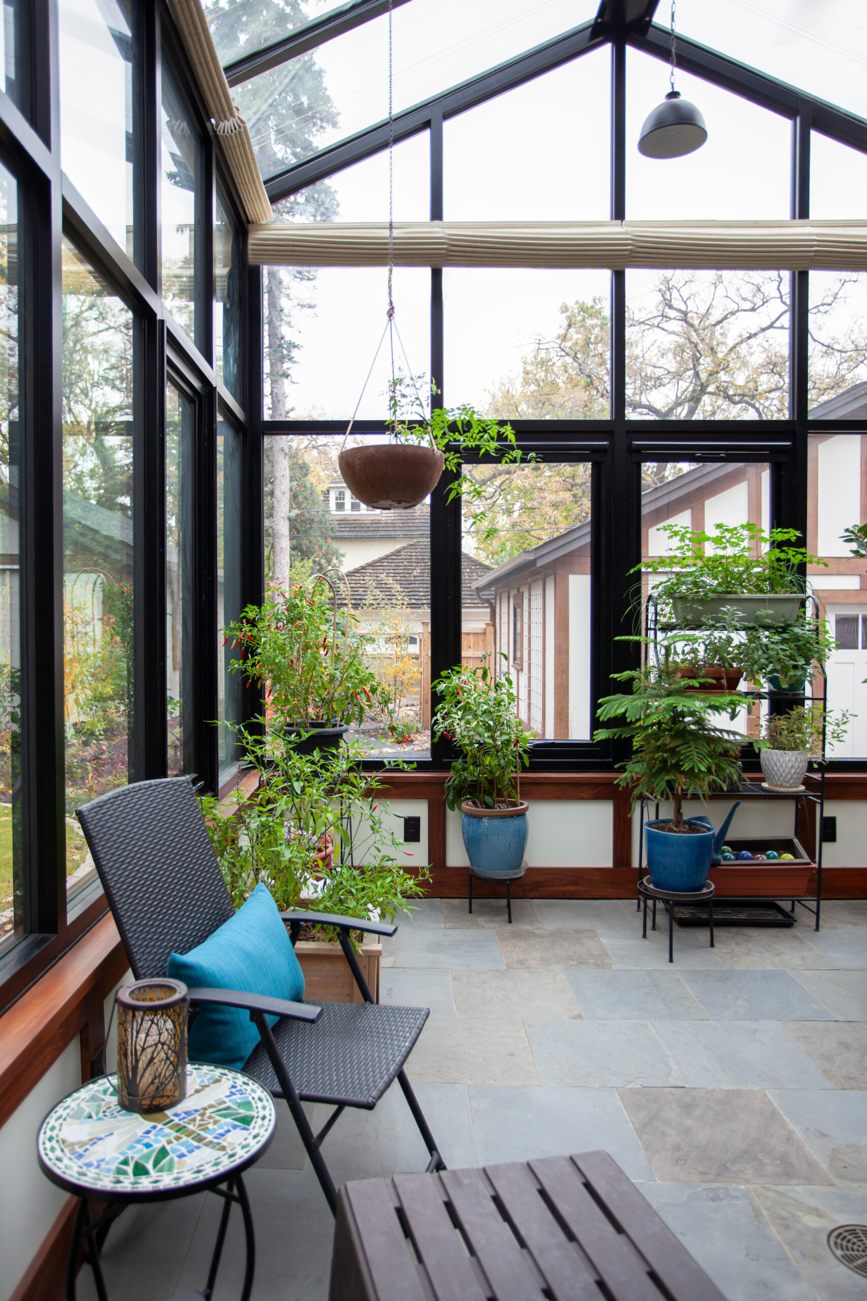Continuous bluestone flooring extending from the home's interior through the conservatory, creating a seamless indoor-outdoor flow
