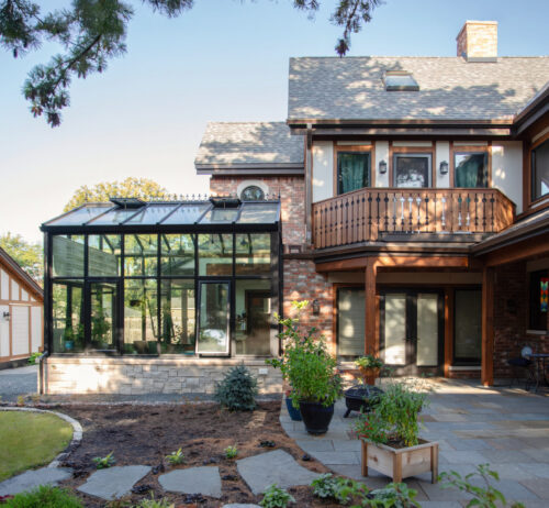 Year-round conservatory with motorized roof vents, automated blinds, and nine-foot sidewalls filled with natural light